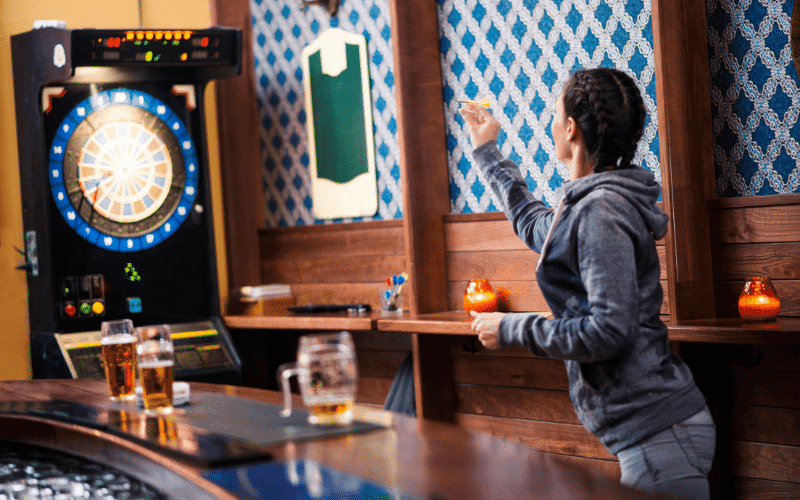 A dart player practices target accuracy and competitive training exercises